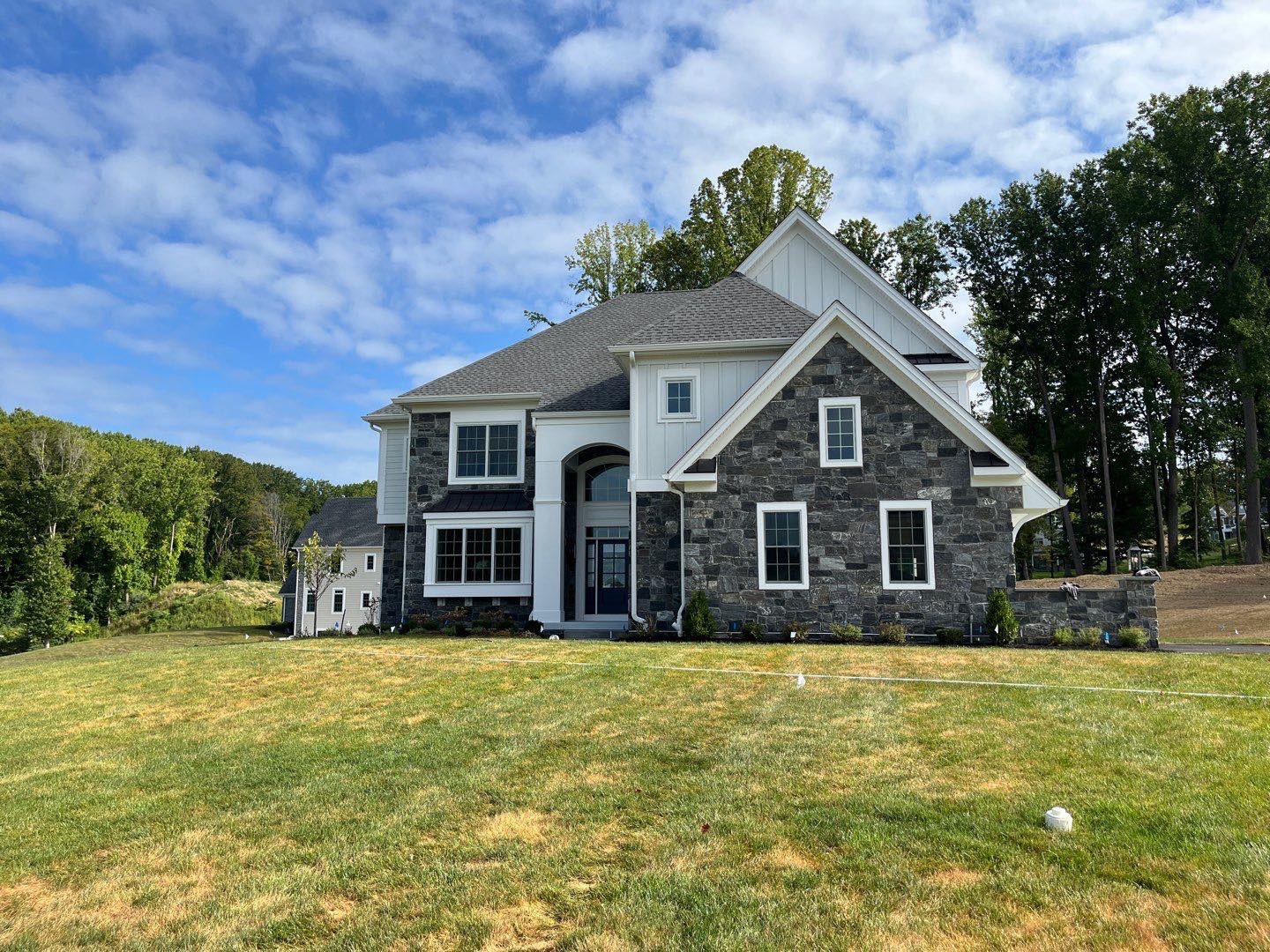 Home in daytime - benefits of outdoor lighting - Burkholder Landscape