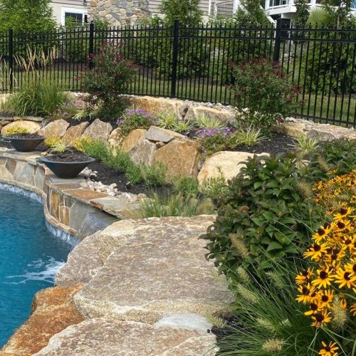 Retaining wall using Techo-Bloc 6” Mini Creta Architectural caps in beautiful chestnut brown, and stone granite boulders - Pool and Patio Retreat - New Projects by Burkholder Landscape