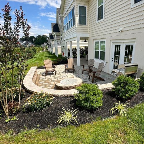 Techo-Bloc Patio with Mini Creta Architectural wall and Valencia firepit - Burkholder Landscape