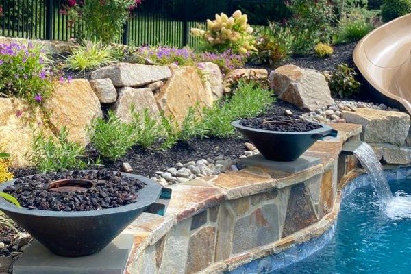 Pool seat walls and steps using Techo-Bloc 6” Mini Creta Architectural caps in beautiful chestnut brown - Pool and Patio Retreat - New Projects by Burkholder Landscape