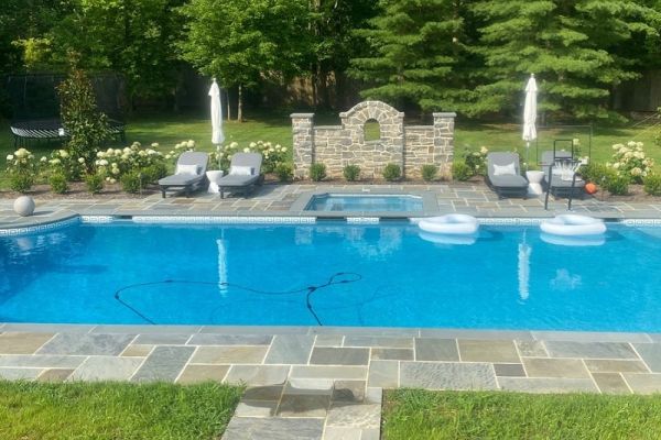 pool with built in spa, flagstone surround and seating | New landscape project | Burkholder Landscape